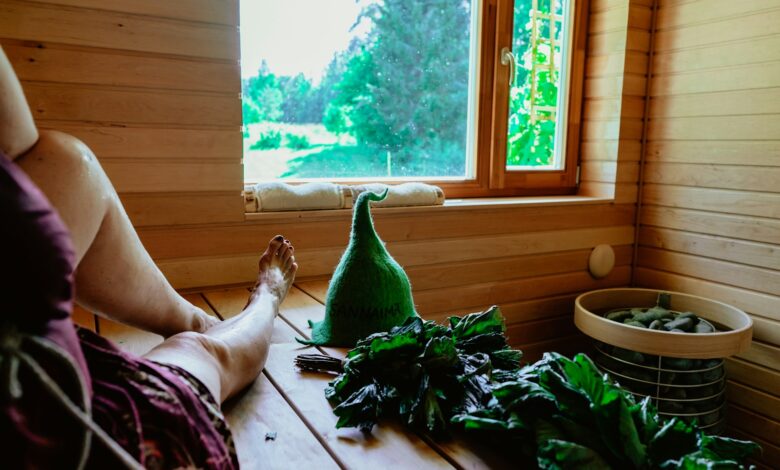a person lying on a bed next to a window with plants