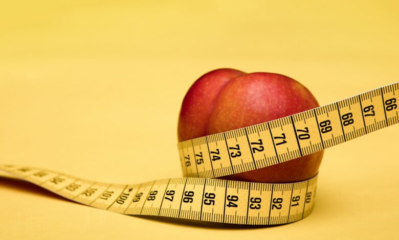 red apple fruit with tape measure